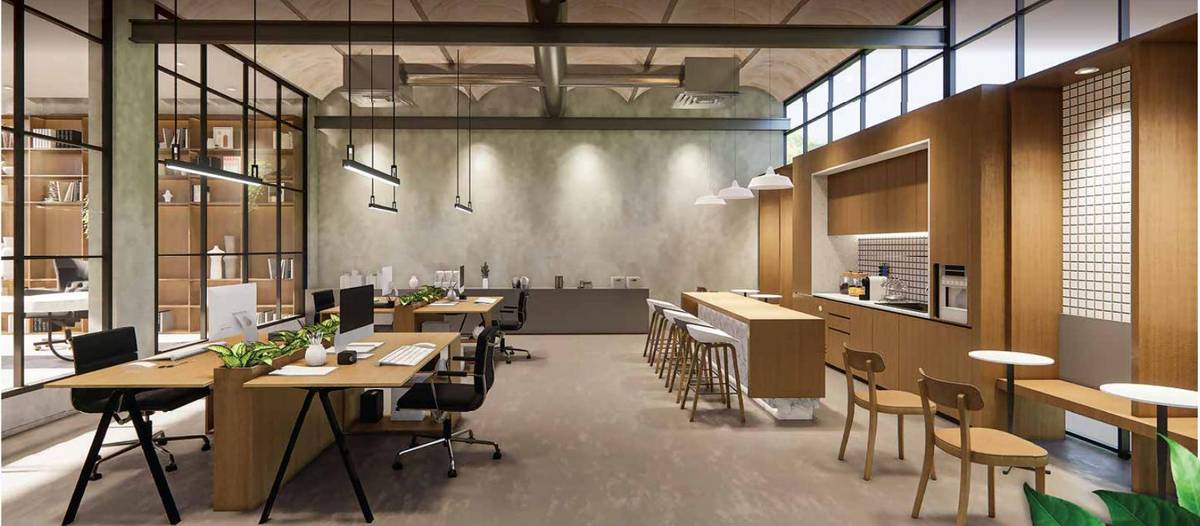 Co-working space with long desks and a café counter